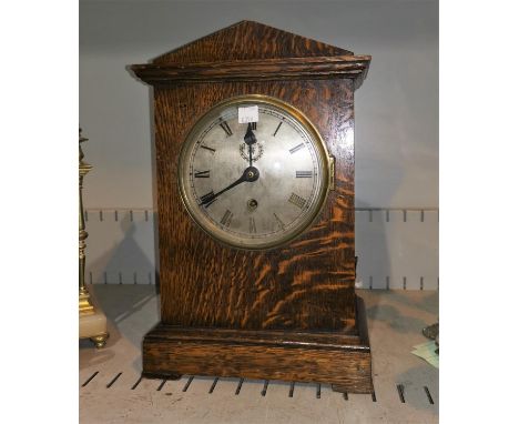 An early 20th century government mantel clock in arch top oak case, the silvered dial with RAF crest, timepiece movement, hei