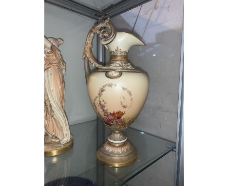 A Royal Worcester ewer, hand painted in polychrome with flowers against a peach blush ground, with ornate acanthus handle, he