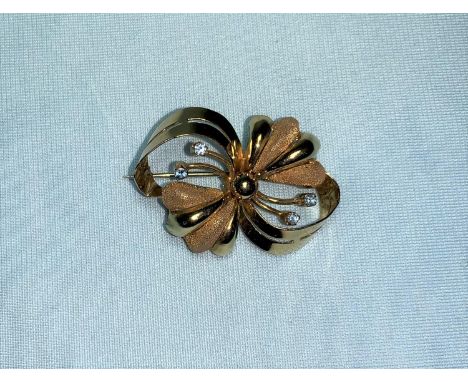 A yellow metal flower head brooch set with 4 light blue stones, stamped '750', tests as 18 ct,  4.9 gm 