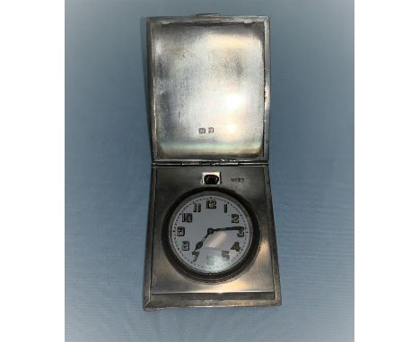 An Art Deco travelling bedside clock in silver case, engine turned decoration, Birmingham 1923, 4.5 oz gross weight 