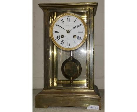 A 19th century brass 4 glass clock, the white enamel dial lettered 'J T Wilkinson, Paris', with bevelled glass panels and 8 d