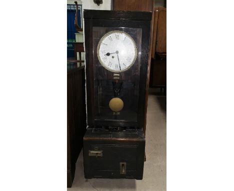An oak cased factory wall clocking in clock with white enamel dial 