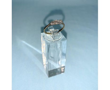 A yellow metal ring set 3 diamonds, marks unclear, size K 