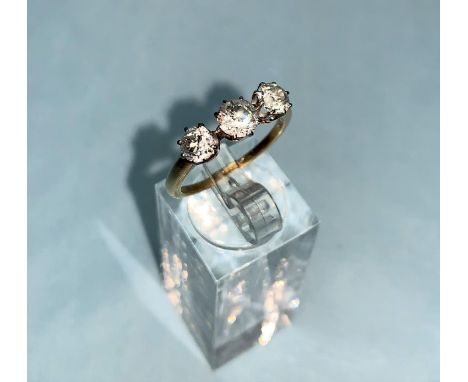 A yellow metal ring set 3 diamonds, central stone .65 ct approx., gross diamond weight 1.5 ct approx., 3.1 gm, size 'O'