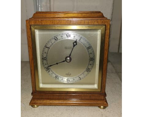 A small oak cased mantel clock by Elliot, height 15 cm; a small oak barometer with thermometer 