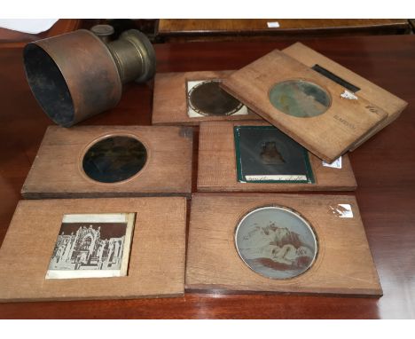 19th century magic lantern slides in wooden frame; a brass magic lantern lens 