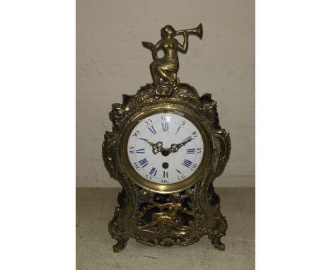 A 19th century brass cased mantel clock with French movement, white enamel dial, figural finial, height 35 cm 