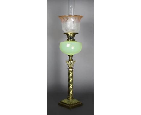 A 19th Century brass table oil lamp, with yellow tinted glass reservoir, 56cm high, with etched orange tinted glass shade and