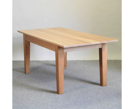 A modern light oak dining table, on square legs, 183 x 86cm