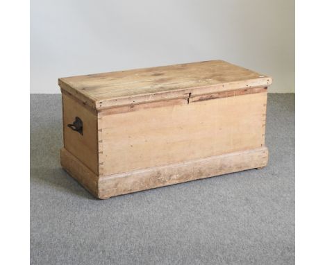 An antique pine trunk, with a hinged lid, 90cm