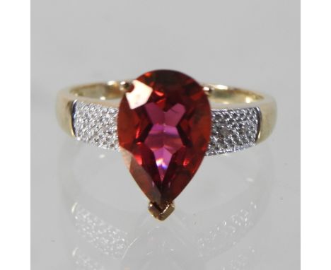A 9 carat gold pink topaz ring, with diamond shoulders, boxed