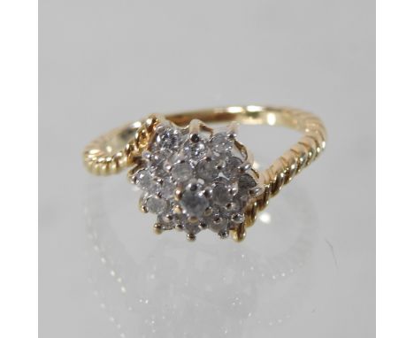 A 14 carat gold diamond cluster ring, boxed
