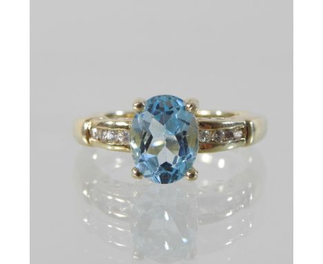 A 9 carat gold blue topaz and diamond ring, boxed