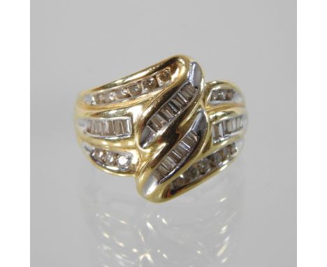 An 18 carat gold and diamond ring, of twisted design, boxed