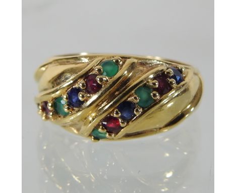 An 18 carat gold multi gem set ring, set with two rows of emeralds and sapphires, boxed