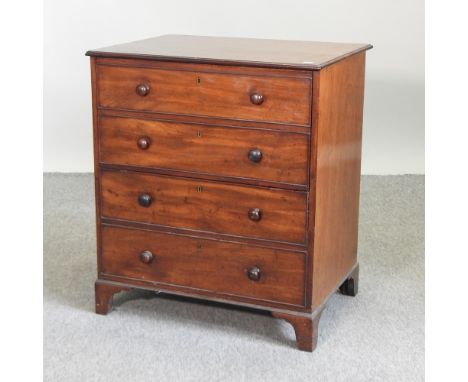 A Georgian style mahogany commode chest, on bracket feet, 68cm