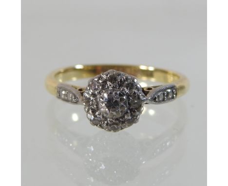 An early 20th century 18 carat gold diamond cluster ring, boxed