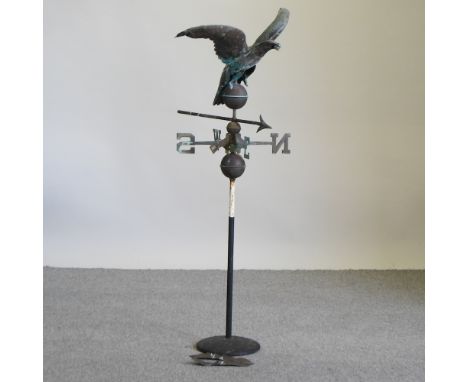 A copper weather vane, surmounted by an eagle, on a stand, 130cm high overall