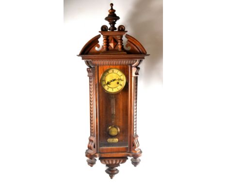 Antique German Vienna style wall clock with Roman numeral dial (W: 13cm) and carved edges and 4 finnials. With pendulum and k