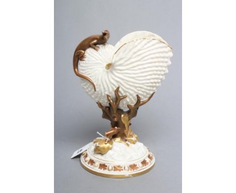 A LATE VICTORIAN ROYAL WORCESTER NAUTILUS VASE surmounted by a lizard, raised upon a bronzed and gilded coral support on shel