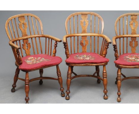 A SET OF SIX ASH AND ELM YORKSHIRE WINDSOR ARMCHAIRS, 19th century, of low hooped bent arm form, the fretted splat with fir t