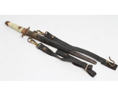 A JAPANESE NAVAL DIRK with 8 1/2" blade, faux shagreen grip, brass hilt mounts, decorative metal scabbard with button release