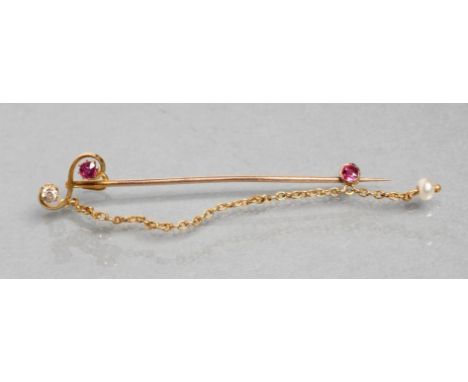 AN EDWARDIAN TIE PIN, the "S" scroll head claw set with a small facet cut ruby and old cut diamond, the safety chain with col