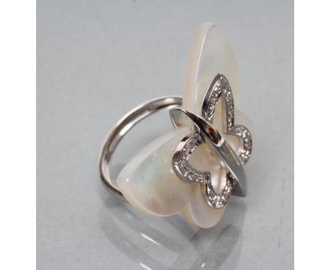 AN ITALIAN DIAMOND DRESS RING, the polished mother of pearl butterfly plaque with a border of pave set stones to a white shan