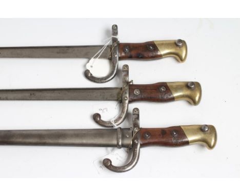 THREE M1874 FRENCH BAYONETS, all with back blade inscriptions, two piece wood grips and one with steel scabbard, 26" includin