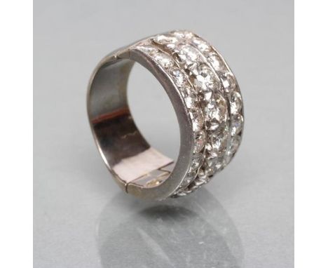 A TRIPLE ROW DIAMOND HALF HOOP RING, the central band channel set with eight brilliant cut stones flanked by two similar band