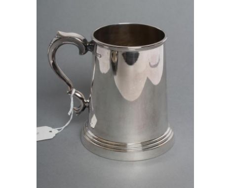 A SILVER MUG, maker Viners, Sheffield 1942, of tapering cylindrical form with double C scroll handle on a stepped foot, engra