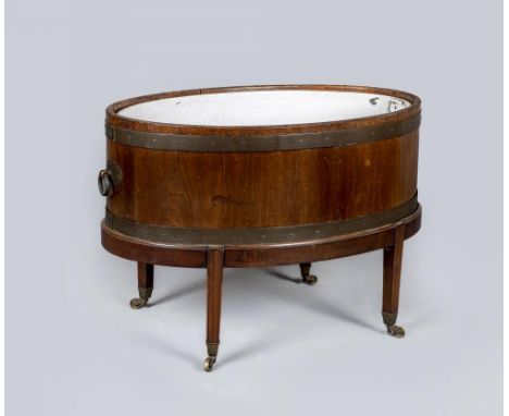 A GEORGIAN MAHOGANY AND BRASS BOUND WINE COOLER, third quarter 18th century, of oval coopered form with brass ring handles an