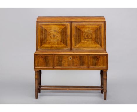 A ROSEWOOD DRINKS CABINET, first half 20th century, of oblong form with stringing, the stepped top over a pair of geometrical