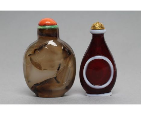 A CHINESE GREY AGATE SNUFF BOTTLE with brown and black shading carved in relief with a hen sitting on a leaf and two fish, 2 