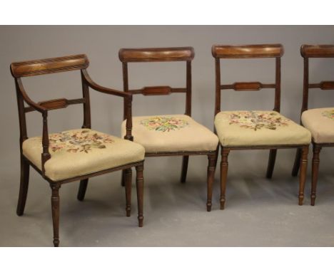 A SET OF EIGHT GEORGIAN MAHOGANY DINING CHAIRS, c.1800, of Sheraton type, and including two elbow chairs, the reeded uprights