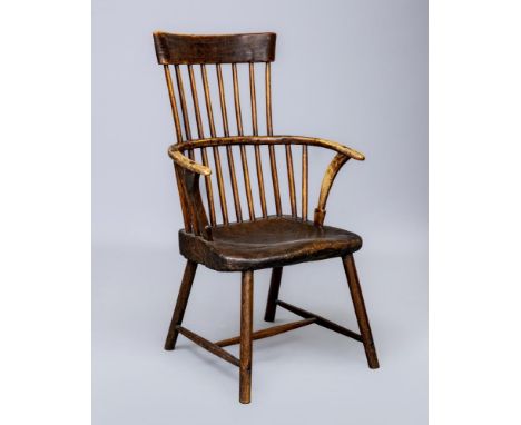 AN ASH COMB BACK WINDSOR ARMCHAIR, Welsh 18th century, with curved top rail, shaped tapering arm supports, primitive oak(?) d