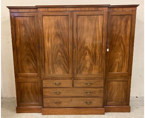 A GEORGIAN MAHOGANY COMPACTUM, early 19th century, of breakfront form with ebony stringing, the moulded and dentil inlaid cor