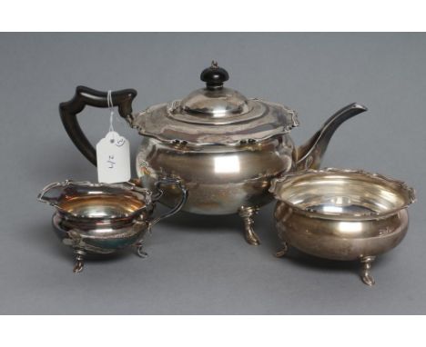 A THREE PIECE SILVER TEA SERVICE, maker's mark HA, Sheffield 1920, of squat globular form with shaped everted rim, raised upo