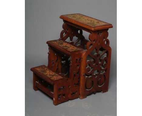 A SET OF VICTORIAN WALNUT FOLDING LIBRARY STEPS, the three steps with inset carpet treads and with pierced scroll fret side p