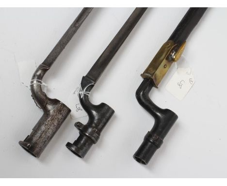 THREE SOCKET BAYONETS, comprising a Martini Henry 1876 bayonet, a possible Brown Bess bayonet and another with cross form bla