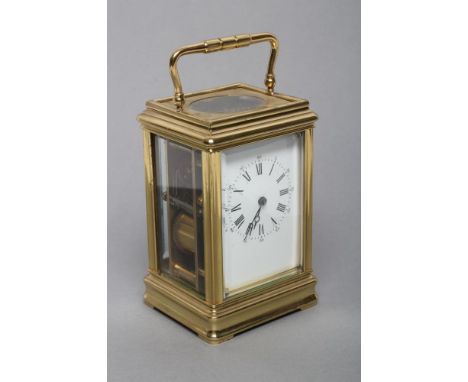 A BRASS CASED CARRIAGE CLOCK, the twin barrel movement with platform escapement striking on a gong, plain white enamel dial w