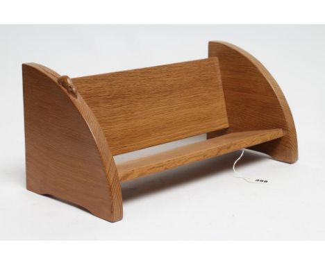 A ROBERT THOMPSON ADZED OAK BOOK TROUGH of oblong form, the quadrant ends with bracket feet, carved mouse trademark in high r