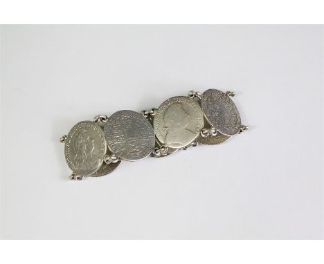 A Vintage Silver Coin Bracelet. The bracelet constructed from seven George IV silver shillings, dated 1723, approx 20 cms, ap