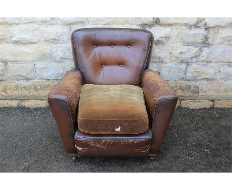 Two Vintage Leather Armchairs. The chairs in various degrees of wear, label bears CC no F661.&nbsp;