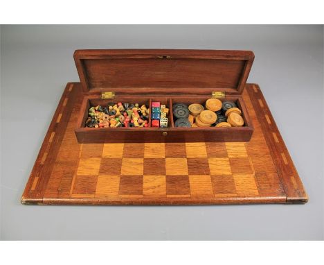 A Vintage Board Game Compendium. This lot includes a carved Halma playing board for backgammon and chess together with a comp