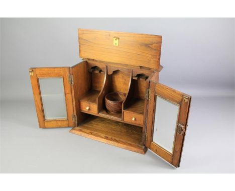 An Edwardian Tobacco/Pipe Smokers Cabinet. The cabinet having two bevelled glass-fronted doors with brass key lock, two pipe 