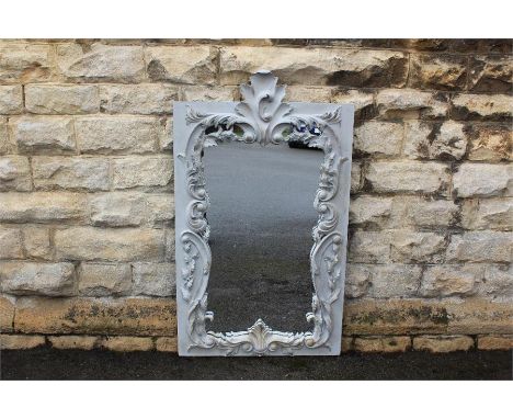 A Large Grey-Painted Over-Mantel Mirror. The mirror of carved foliate scroll design, approx 78 x 132 cms h (some minor chips 