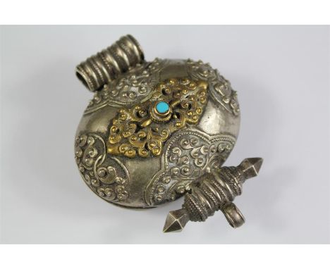 An Antique Tibetan Oval Silver Gau Amulet Box. The silver amulet pendant box being of circular design with foliate decoration