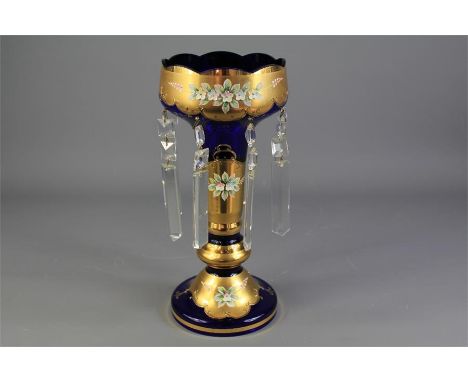 A Mid-20th Century Bohemian Blue Glass Table Lustre. The table lustre with eight crystal faceted drops, gold-coloured enamel 