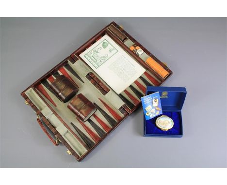 A Vintage Backgammon Set. The set contained within a leather case with instructions booklet and playing pieces together with 